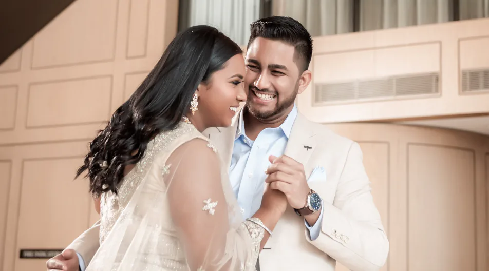 Couple walking through a garden during a Grand House wedding