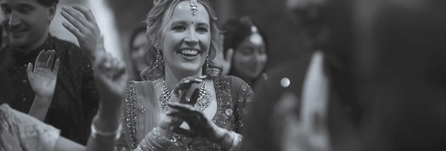 Bride smiling and clapping during a Grand House wedding celebration